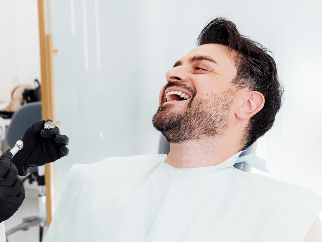 dental patient laughing during dentist appointment with lindenhurst dental health