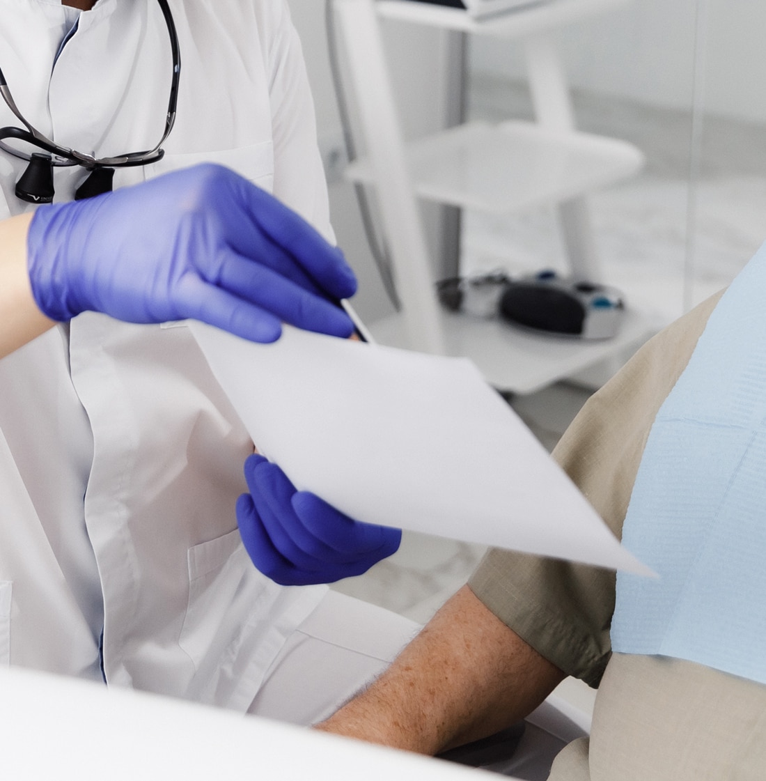 dr chung showing a paper to dental patient at lindenhurst dental health